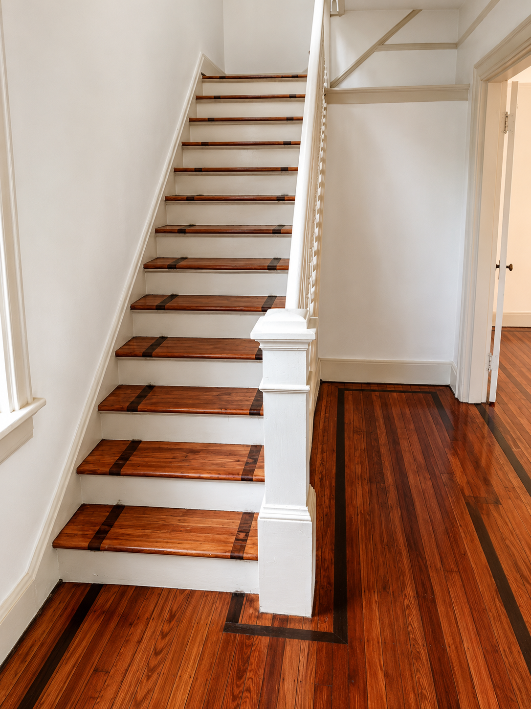 Cherry hardwood staircase with dark walnut inlay treads and matching bordered flooring