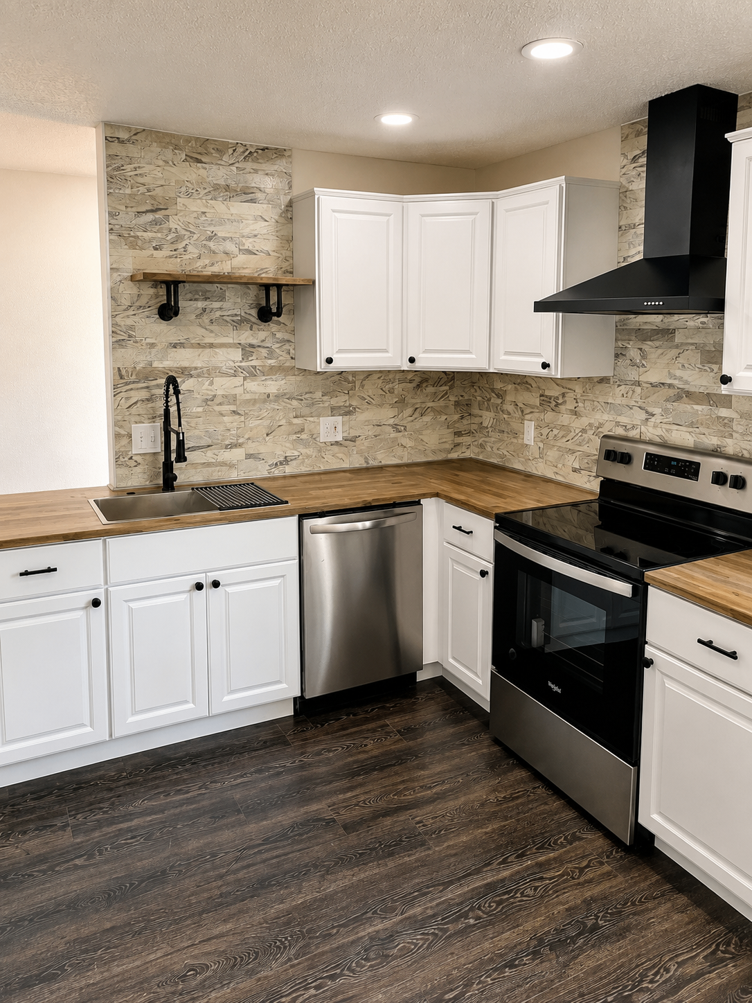 White shaker kitchen with butcher block counters, stone backsplash, and matte black hood
