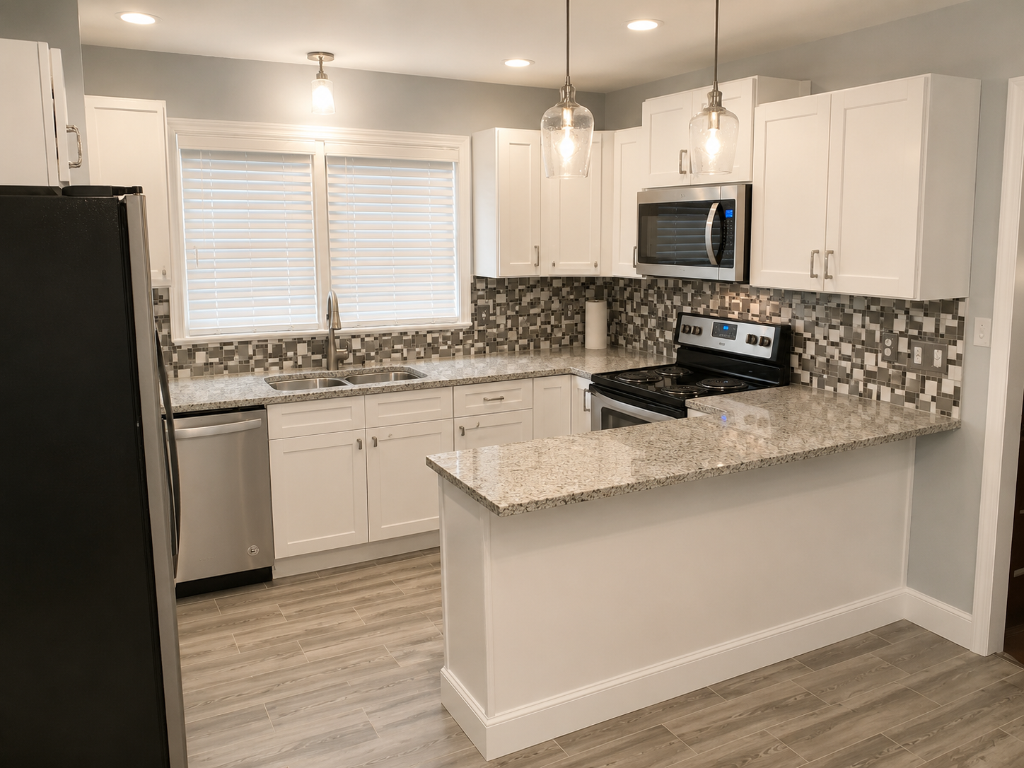 White shaker kitchen with mosaic tile backsplash, granite counters, and pendant lighting
